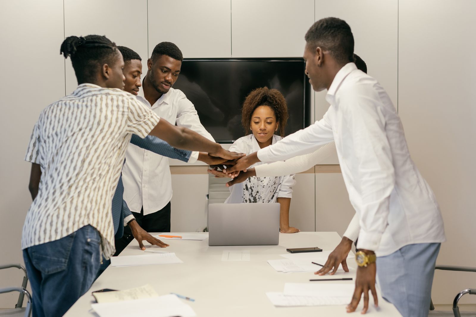 A Kenyan business team working together on connected systems in a modern office